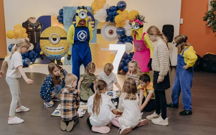 Two entertainers playing games with children at a birthday party